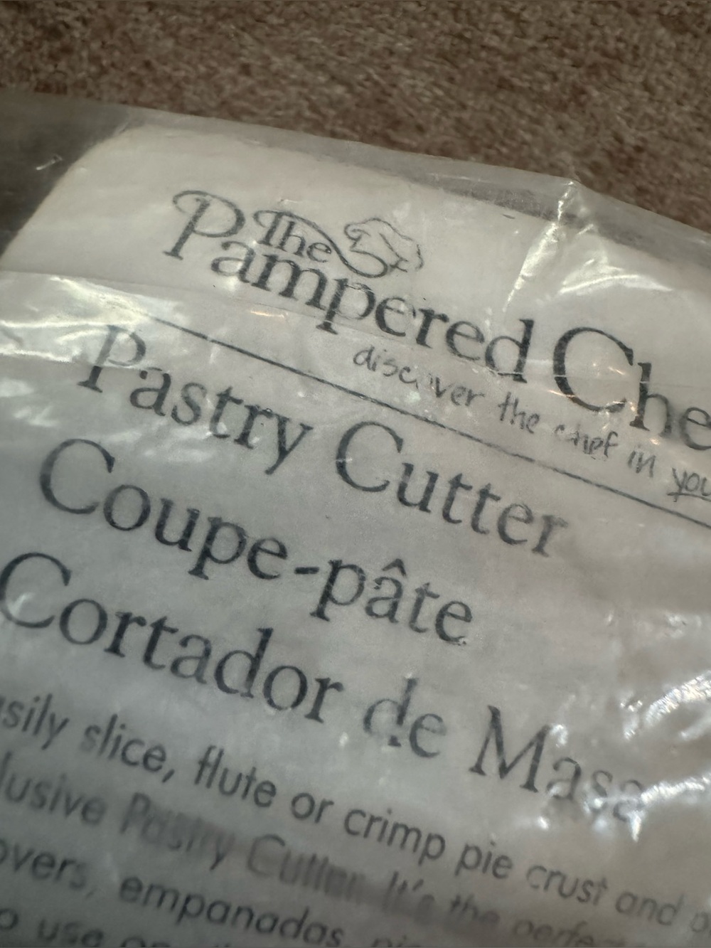 The Pampered Chef Pastry Cutter Packaging - White and Black Text